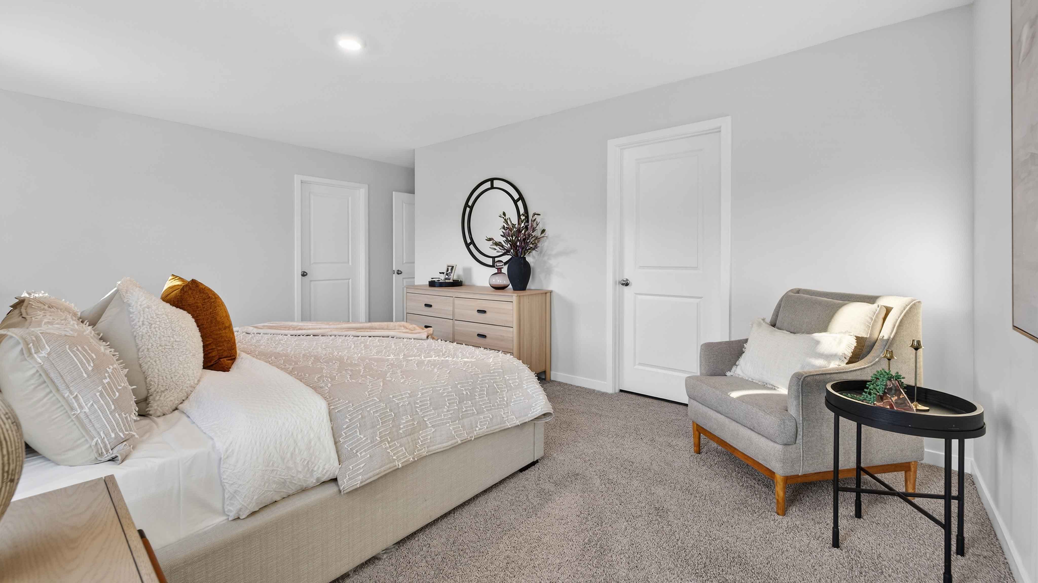 Primary bedroom, carpeted with two large windows