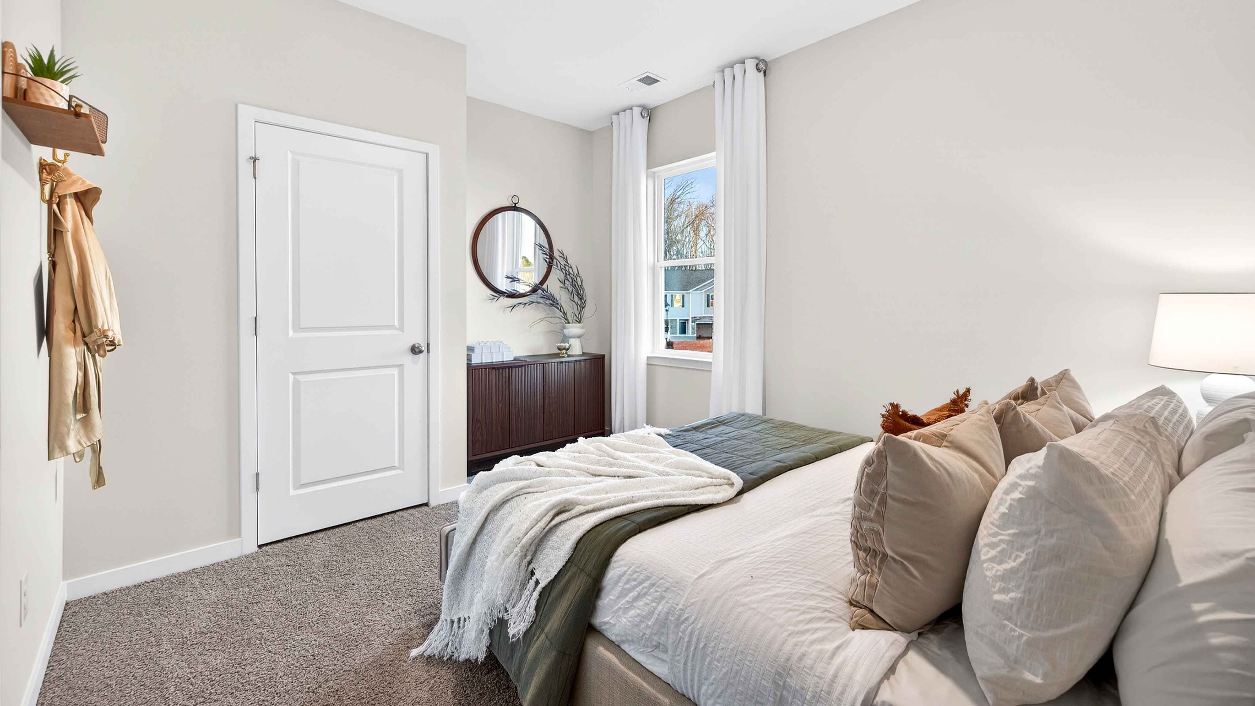 Carpeted bedroom with large window