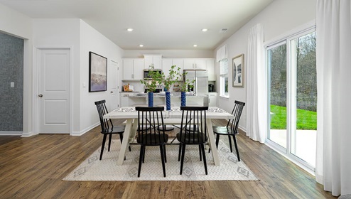 Fergus Crossing Penwell Model Dining room with wood floors, and sliding glass back door