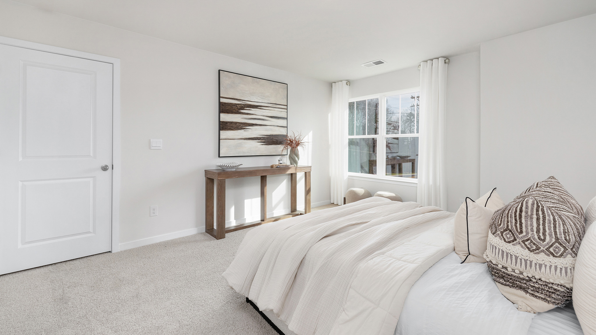 Carpeted bedroom with windows