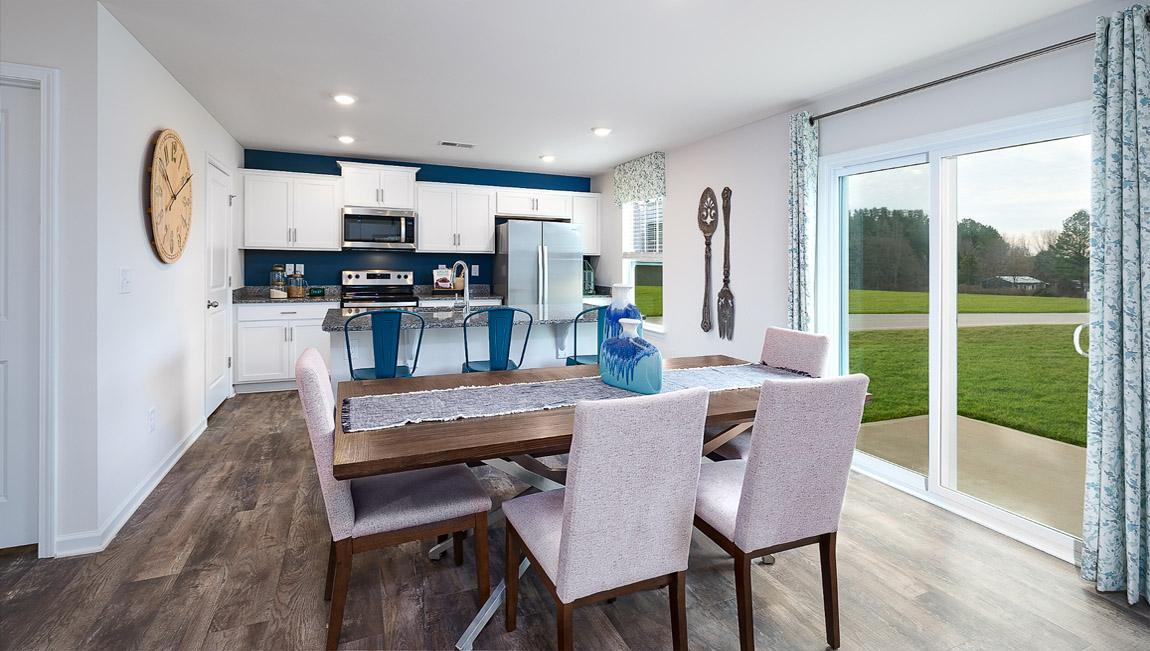 Dining area by kitchen, beside sliding glass doors outside