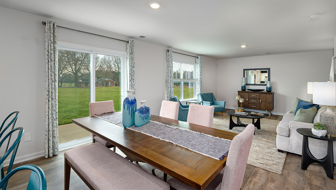 Dining area by kitchen, beside sliding glass doors outside