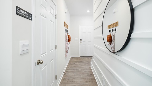 Fergus Crossing Townhomes Newton Model welcoming foyer with wood floors, and white walls