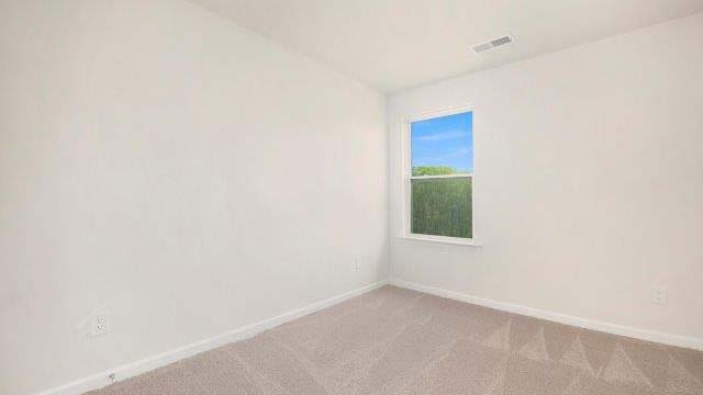 Carpeted bedroom with small window