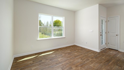 Family room with large window, beside kitchen