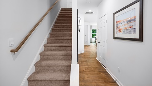 Fergus Crossing Townhomes Newton Model welcoming foyer with wood floors, and white walls