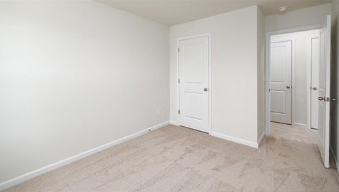 Carpeted bedroom with small window