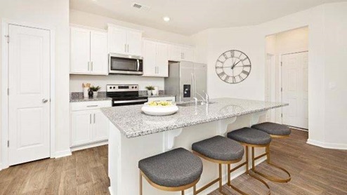 Fergus Crossing Townhomes Model Kitchen and island, white cabinets