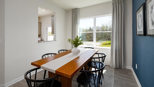 Fergus Crossing Townhomes Newton Model dining room with wood floors and large window