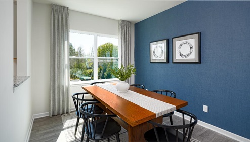 Fergus Crossing Townhomes Newton Model dining room with wood floors and large window