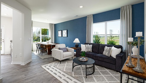 Fergus Crossing Townhomes Newton Model modern open family room with wood floor and large window