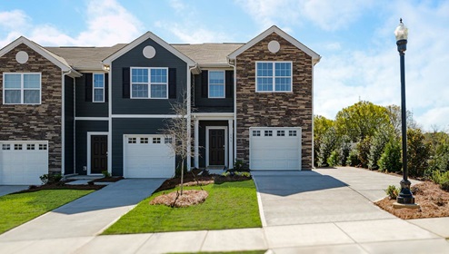 Fergus Crossing Townhomes Newton Model front exterior with stone and siding, and one car garage