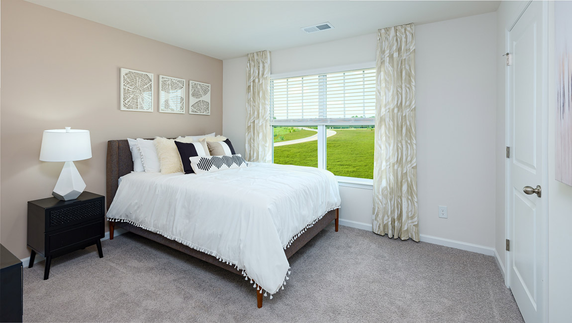 Carpeted bedroom with windows