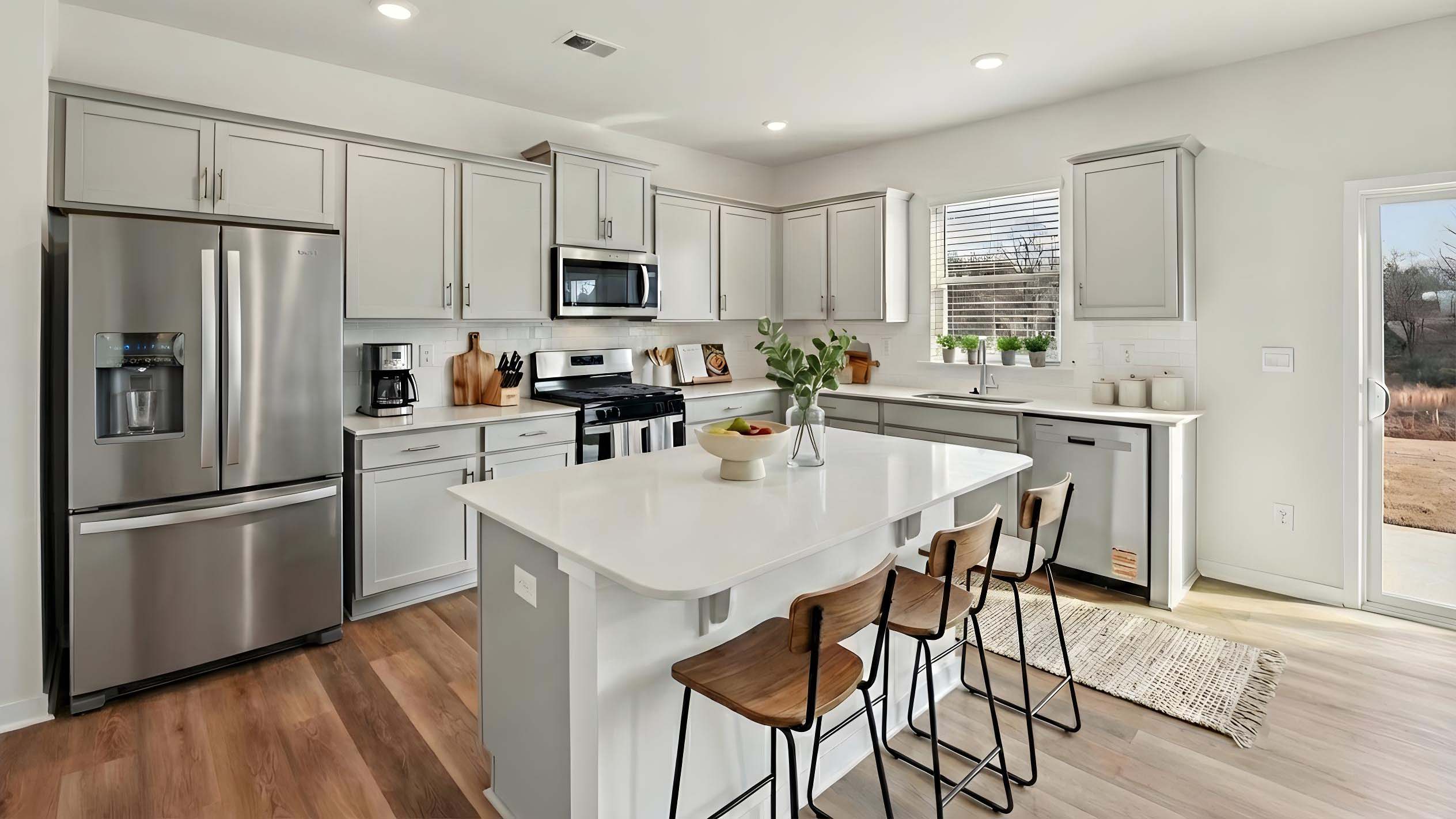 Kitchen and island with stainless steel appliances