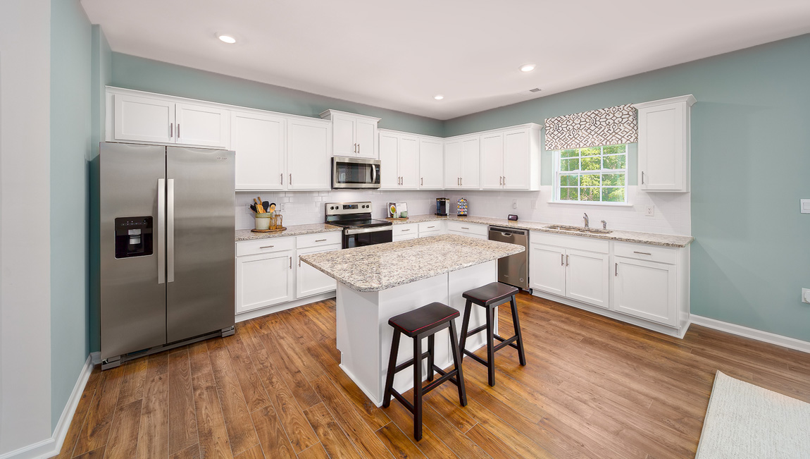 Kitchen and island with white cabinets and counters