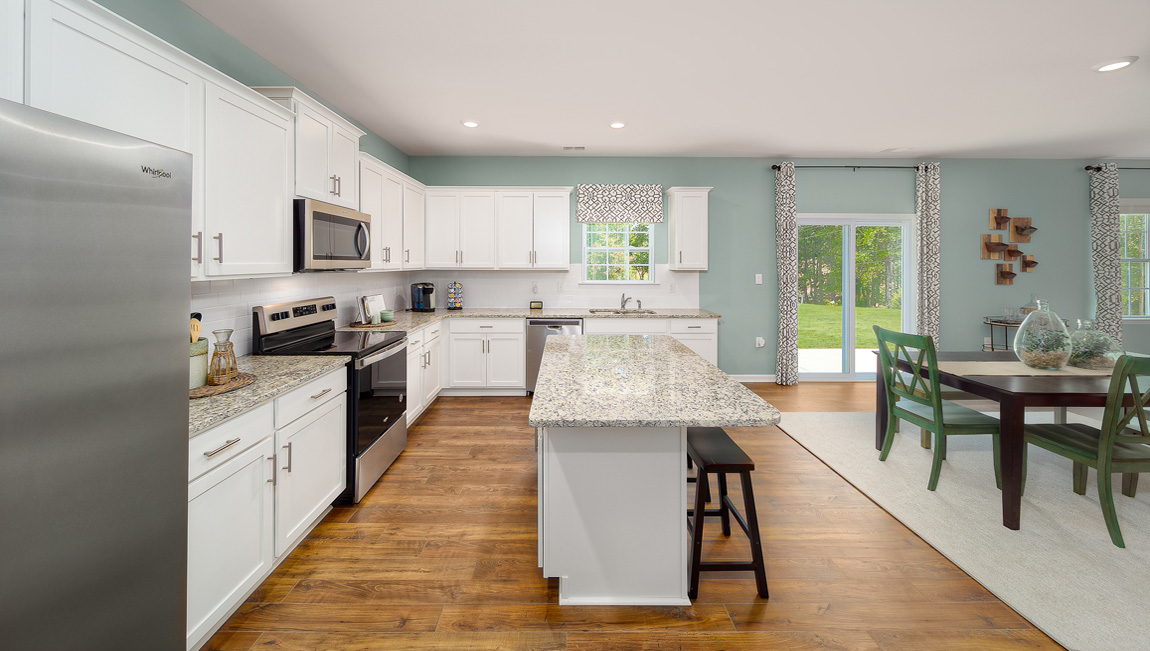 Kitchen and island with white cabinets and counters