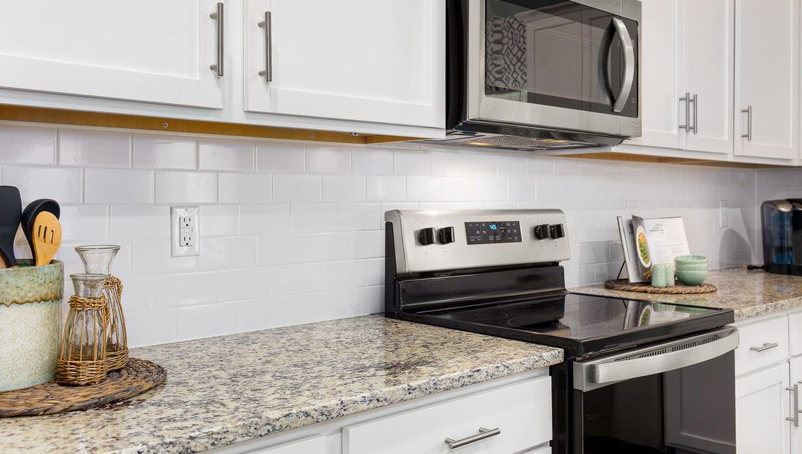 Kitchen and island with white cabinets and counters