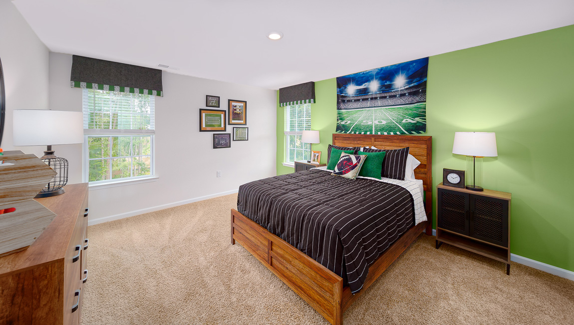 Carpeted bedroom with two large windows