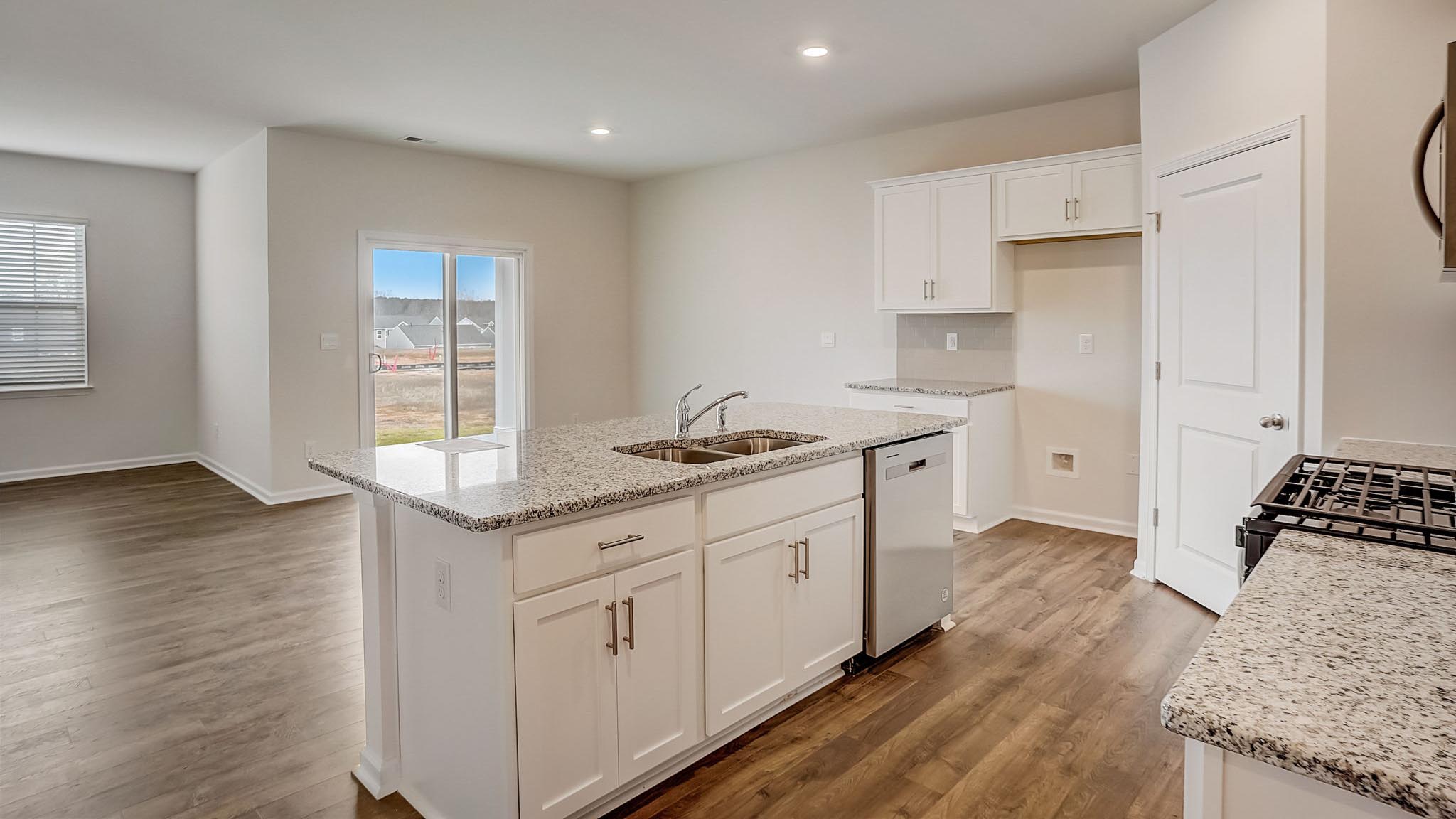 Kitchen and island with white cabinets and subway tiles and stainless steel subway tiles