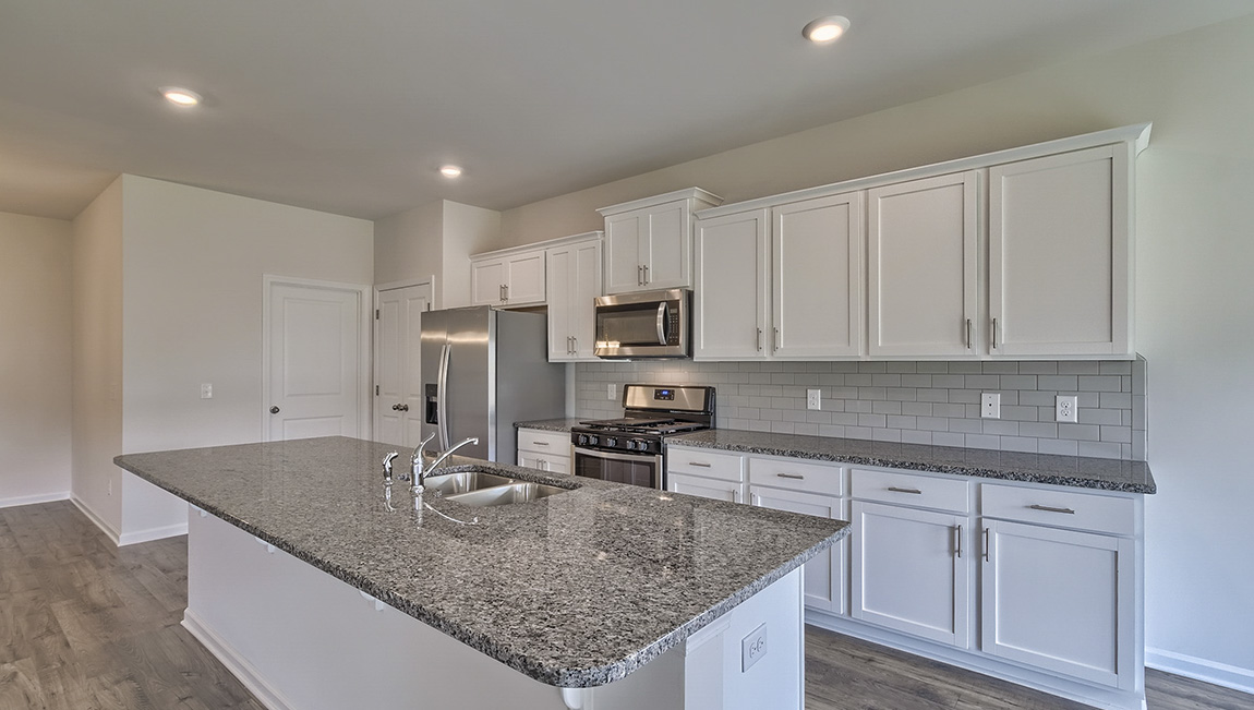 Kitchen and island with white cabinets
