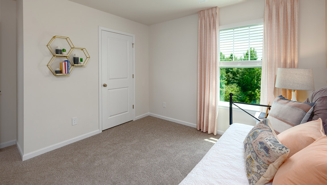 Carpeted bedroom with window