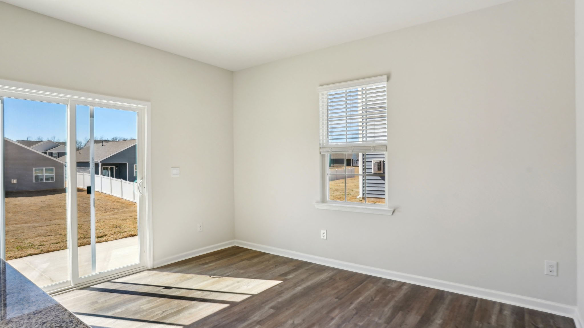 Breakfast area beside kitchen with sliding glass back door and small window