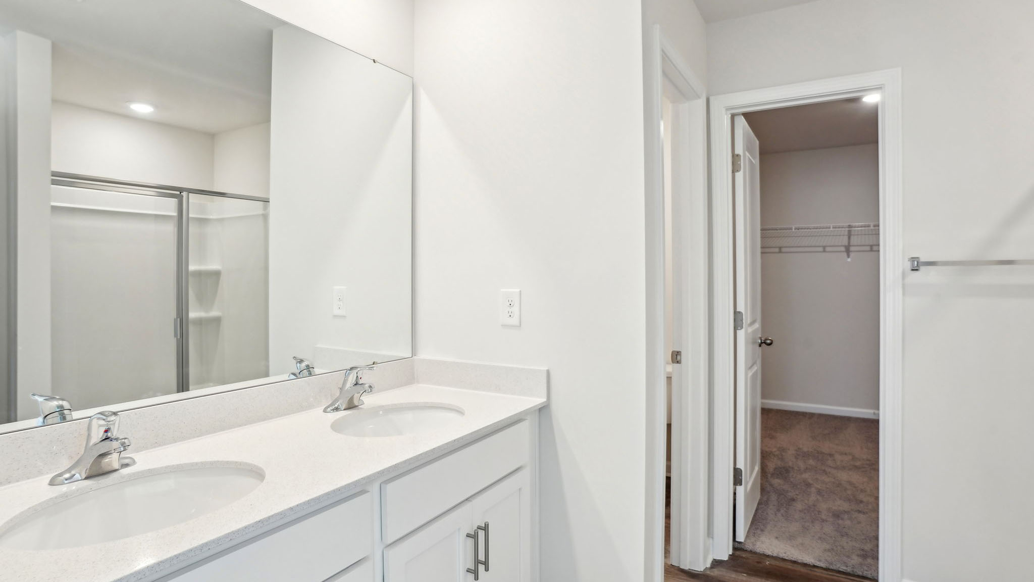 Primary bathroom with double sink vanity  and standing shower