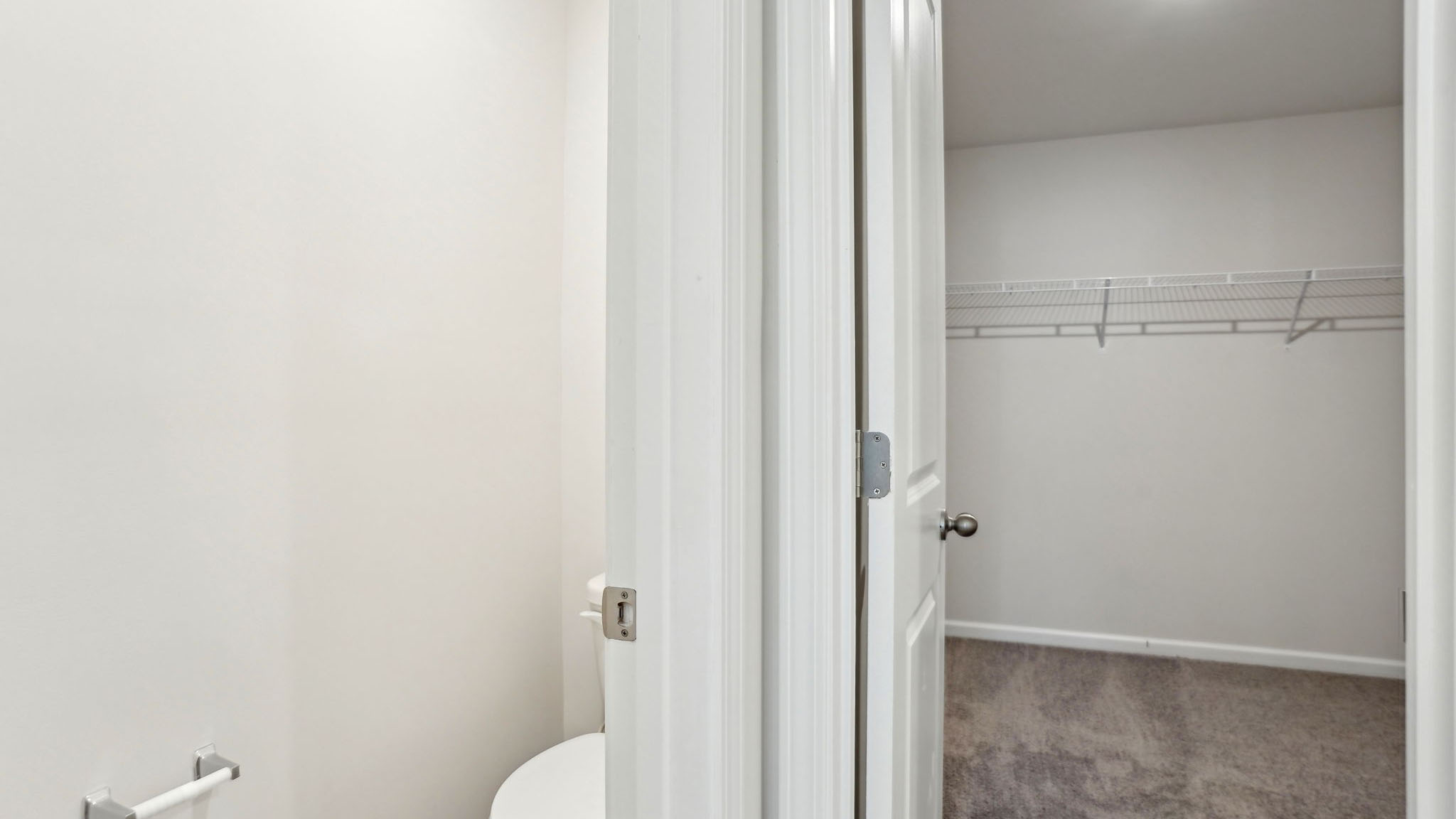 Primary bathroom with attached walk in closet