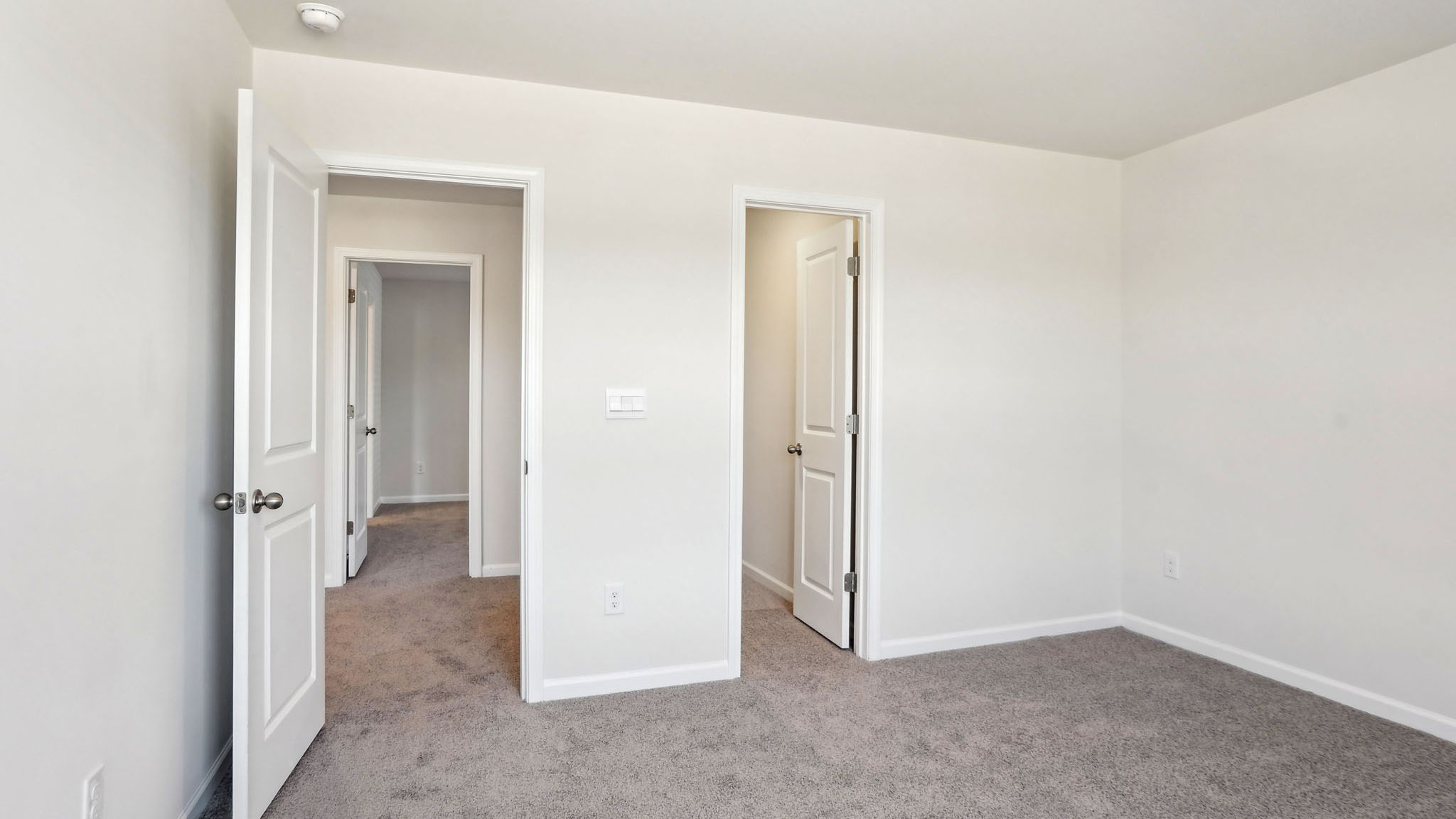 Carpeted bedroom with large window