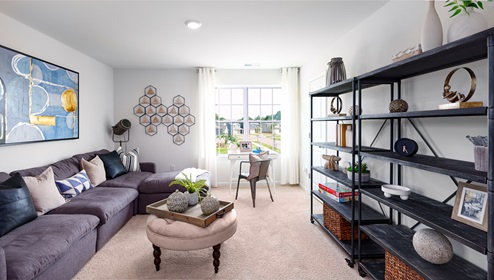 Carpeted loft space atop stairs with large window