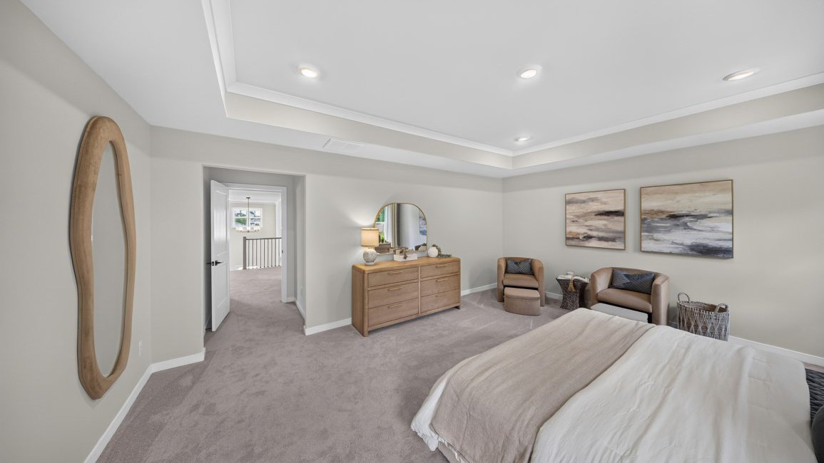 Primary carpeted bedroom with windows