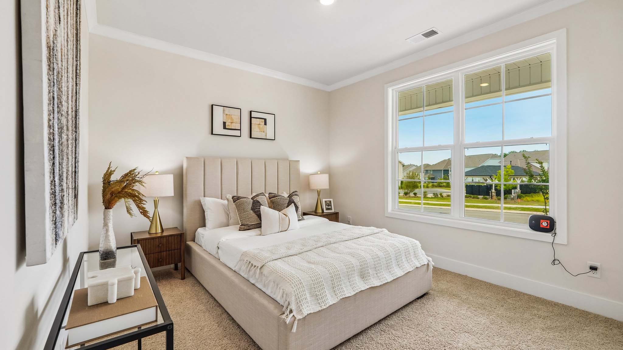 Carpeted bedroom with windows