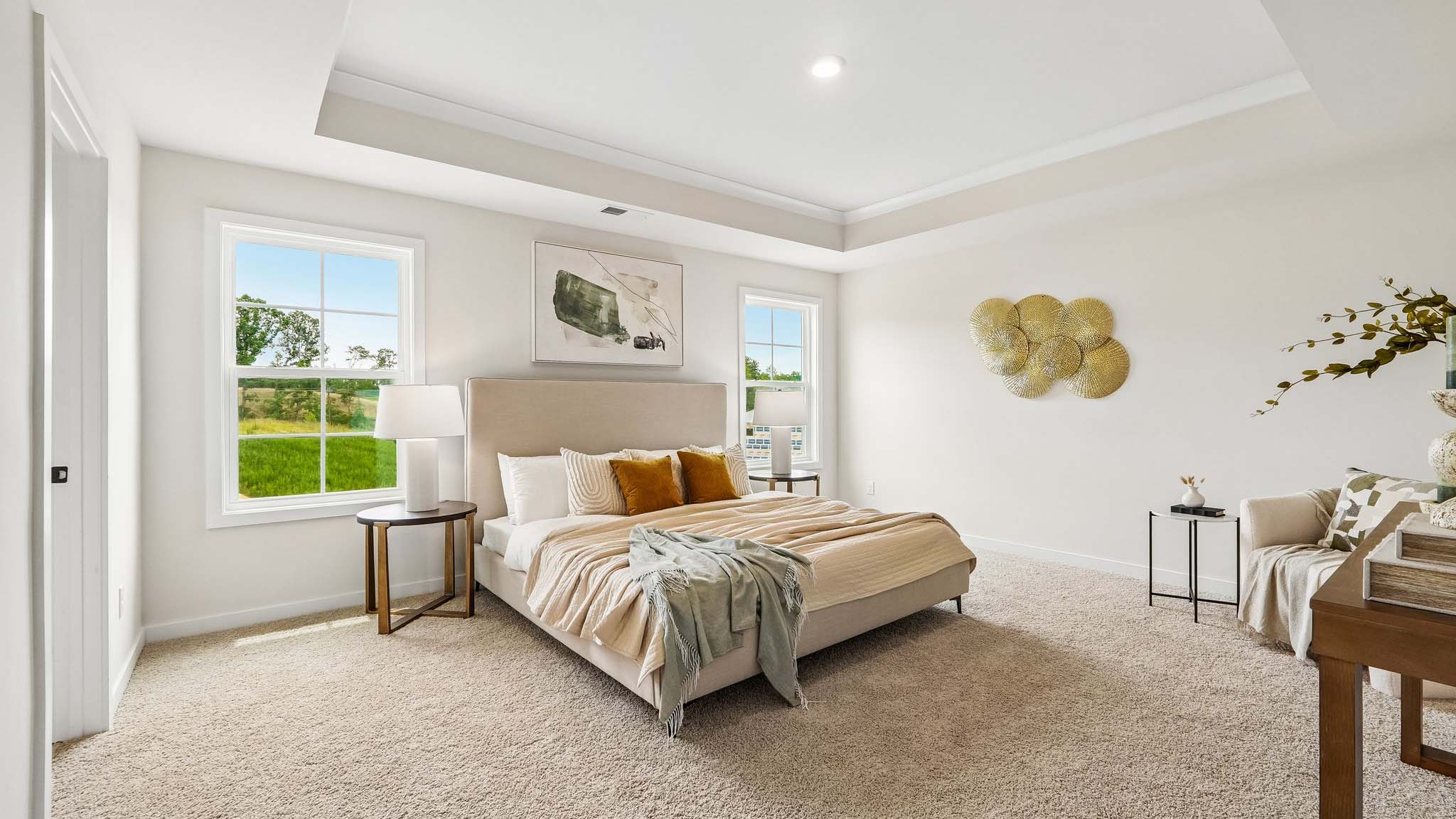Primary carpeted bedroom with windows