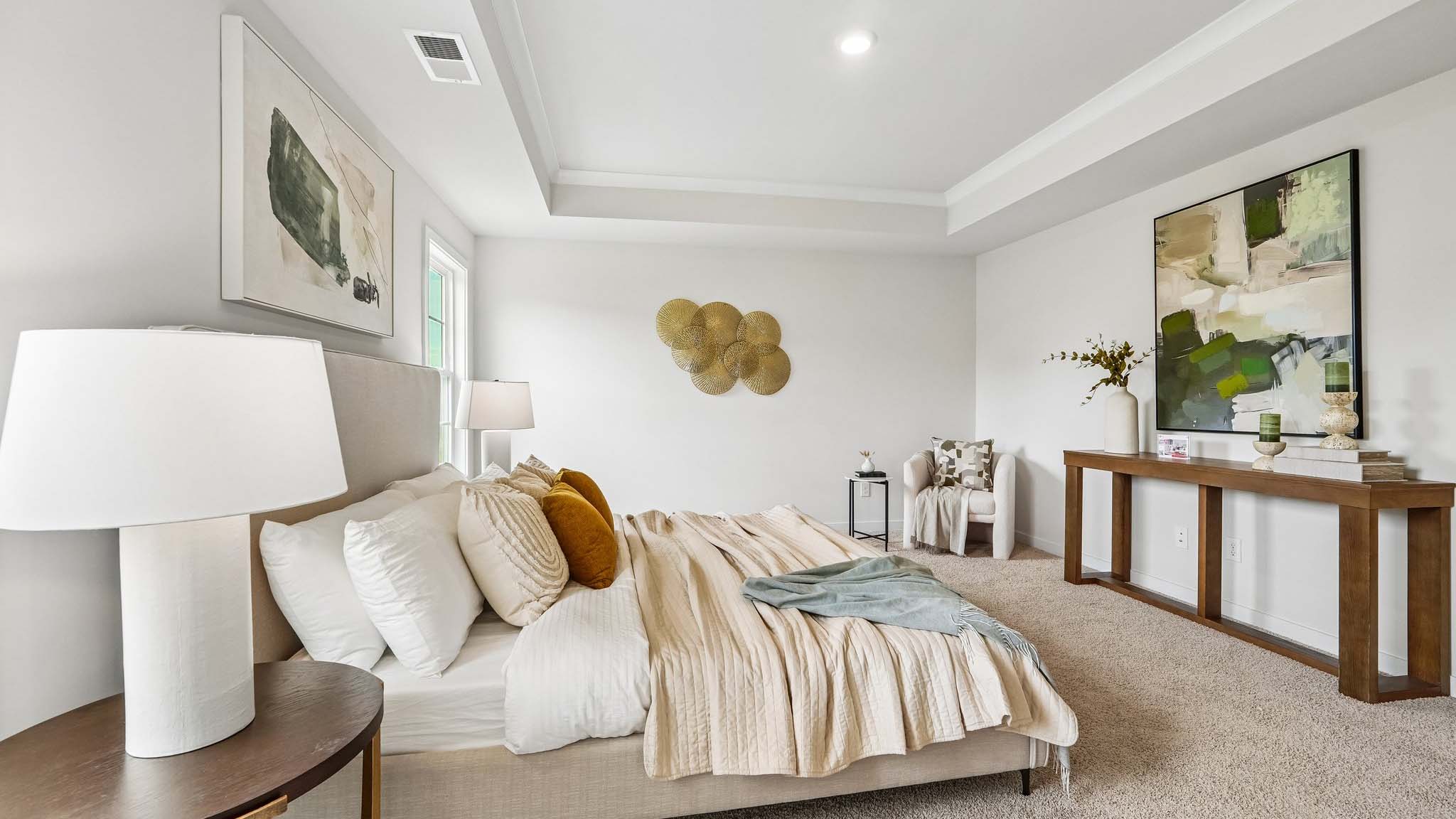 Primary carpeted bedroom with windows