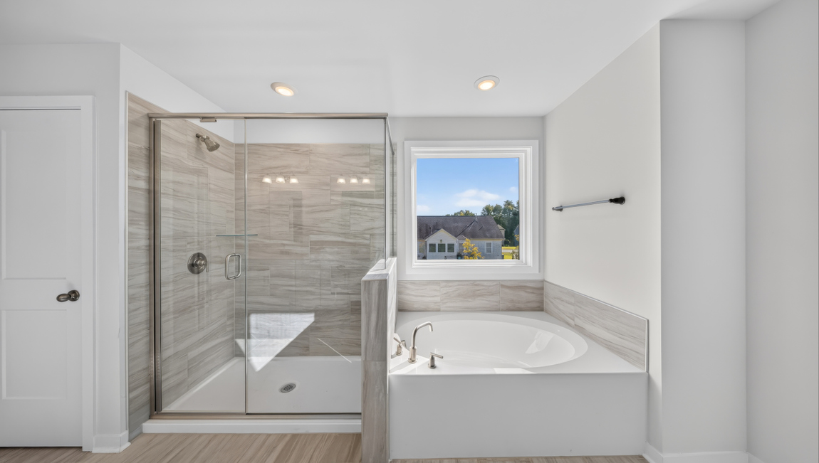 Primary bathroom with standing glass shower and double sinks