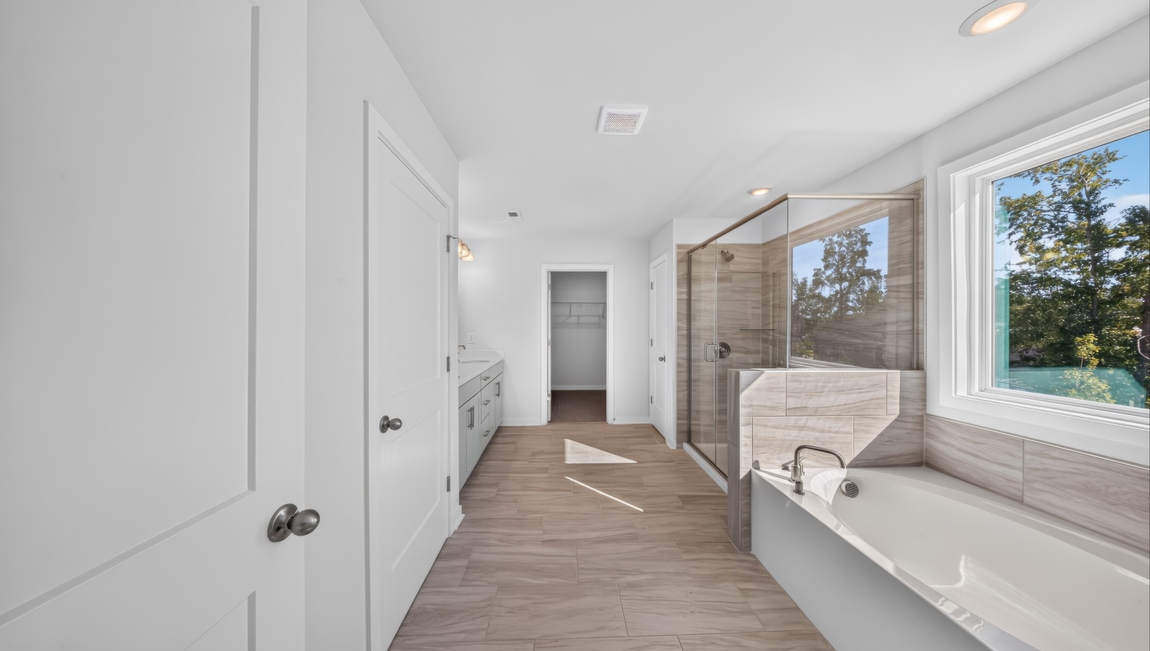 Primary bathroom with standing glass shower and double sinks