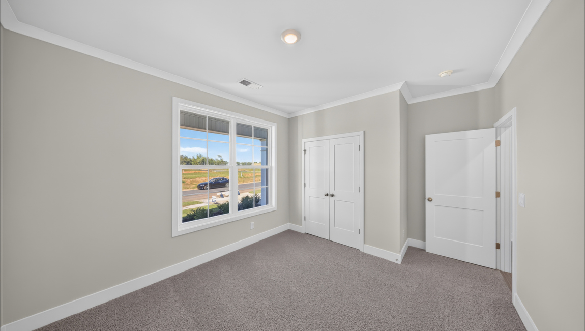 Carpeted bedroom with windows