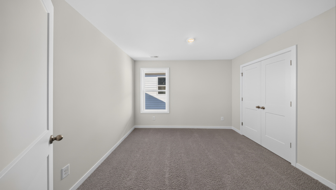 Carpeted bedroom with windows