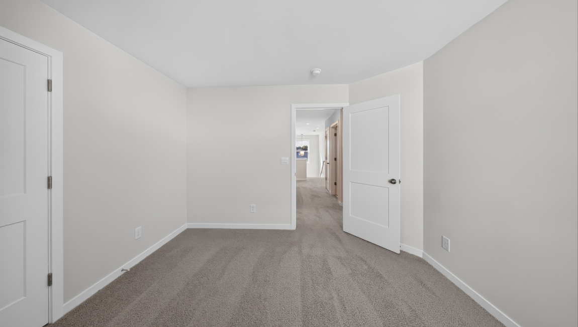 Carpeted bedroom with windows