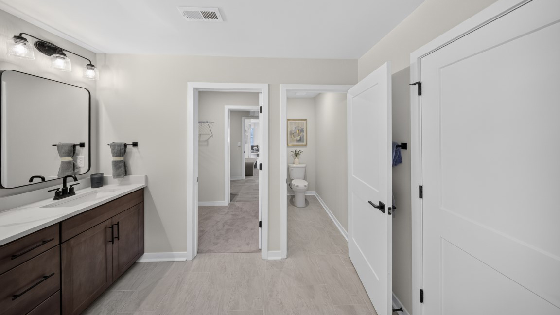 Primary bathroom with standing glass shower and double sinks