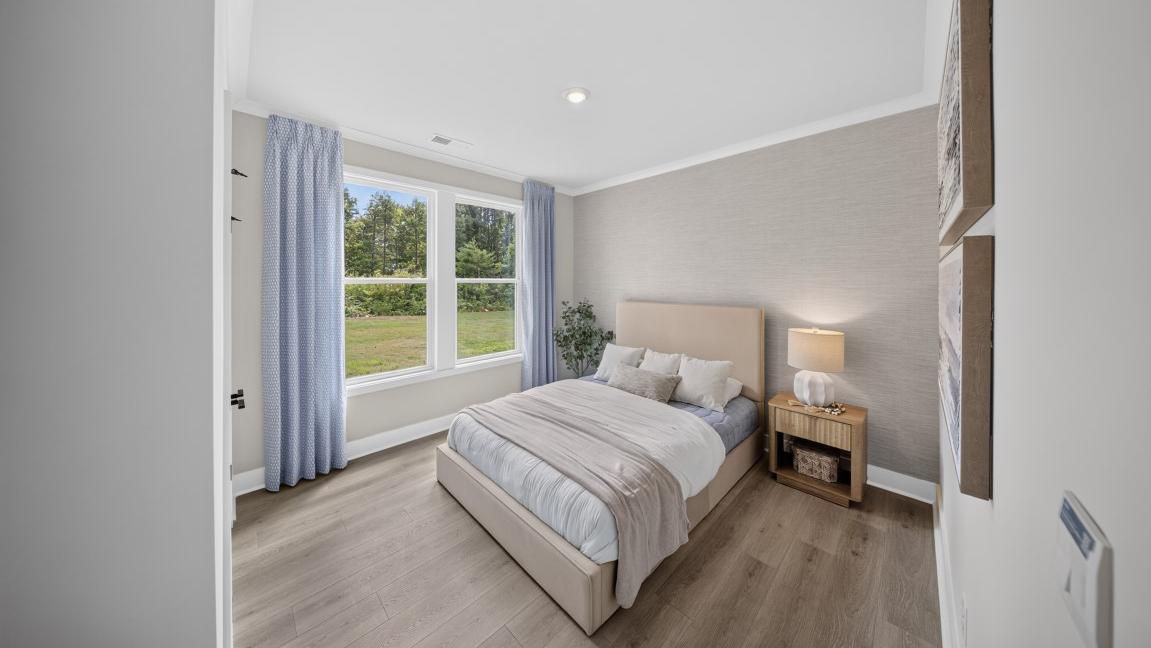 Carpeted bedroom with windows