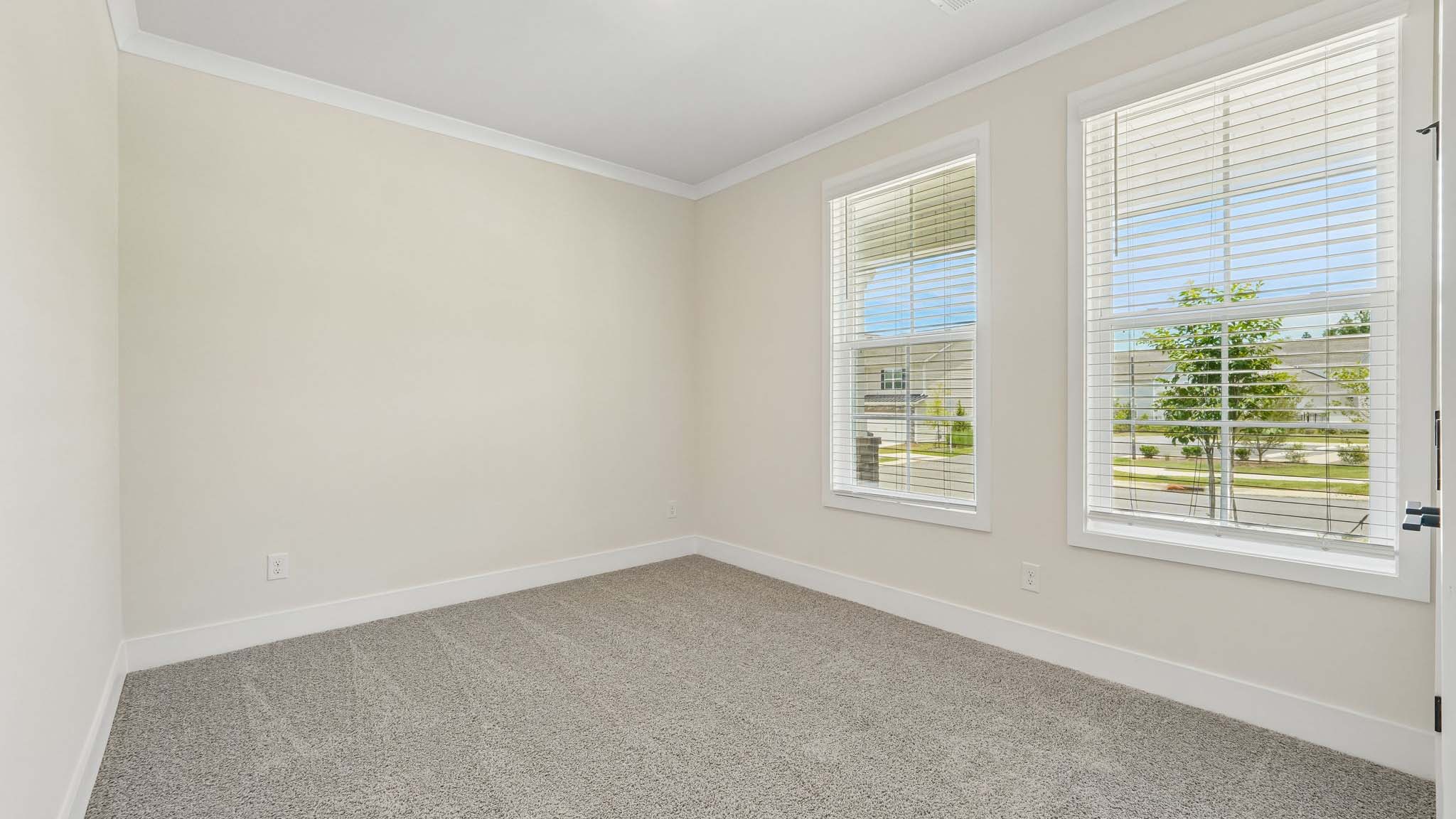 Carpeted bedroom with windows