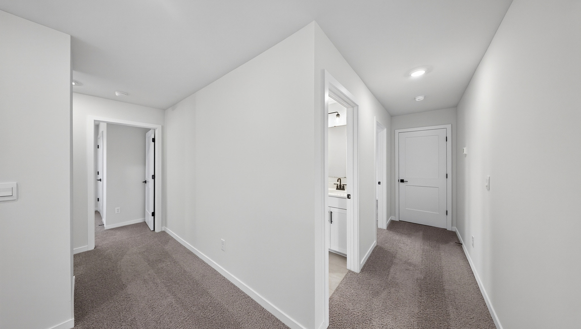 Carpeted bedroom with windows