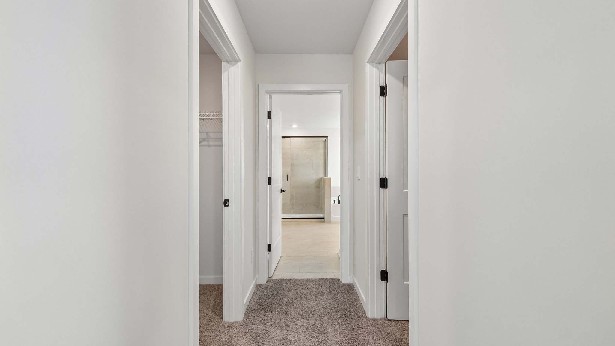 Primary carpeted bedroom with windows