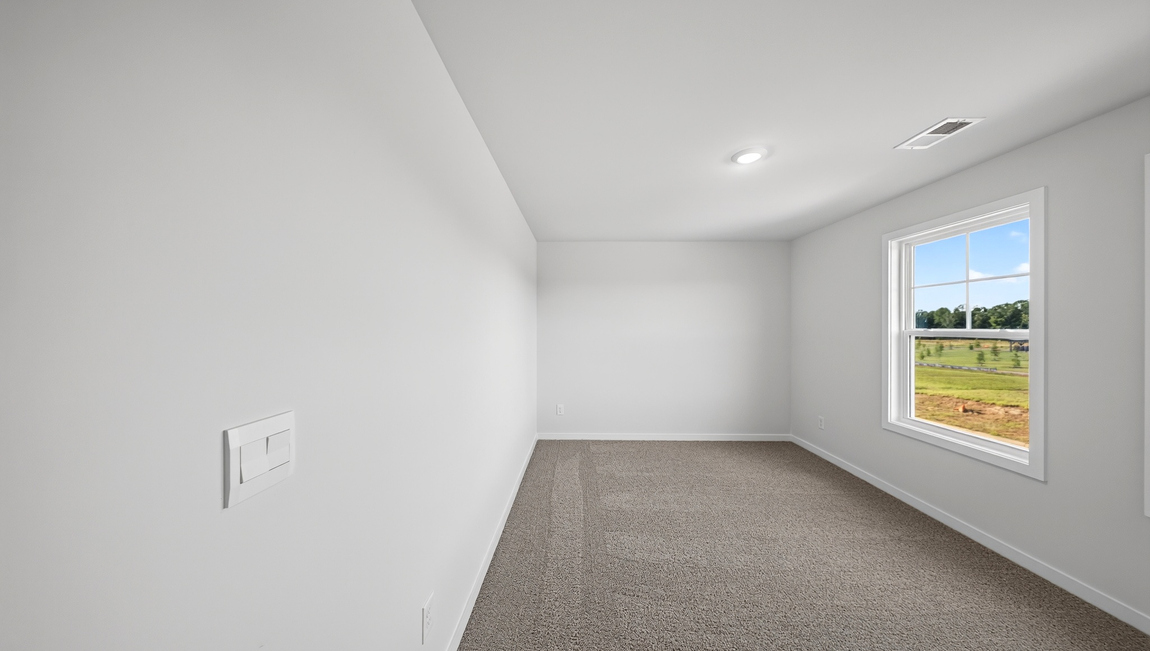 Carpeted bedroom with windows