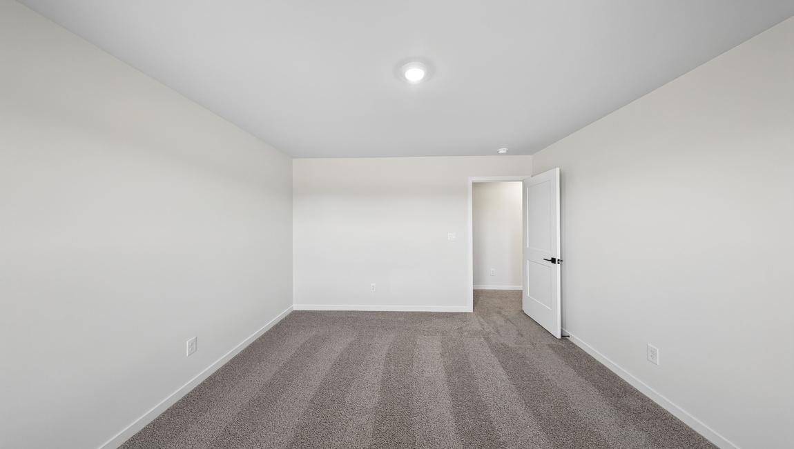 Carpeted bedroom with windows