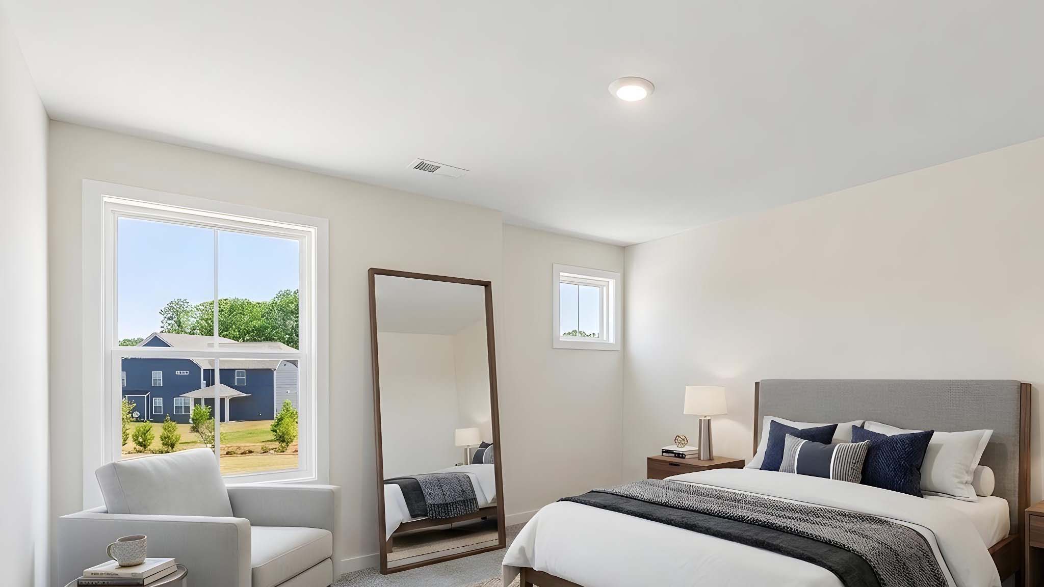 Carpeted bedroom with windows