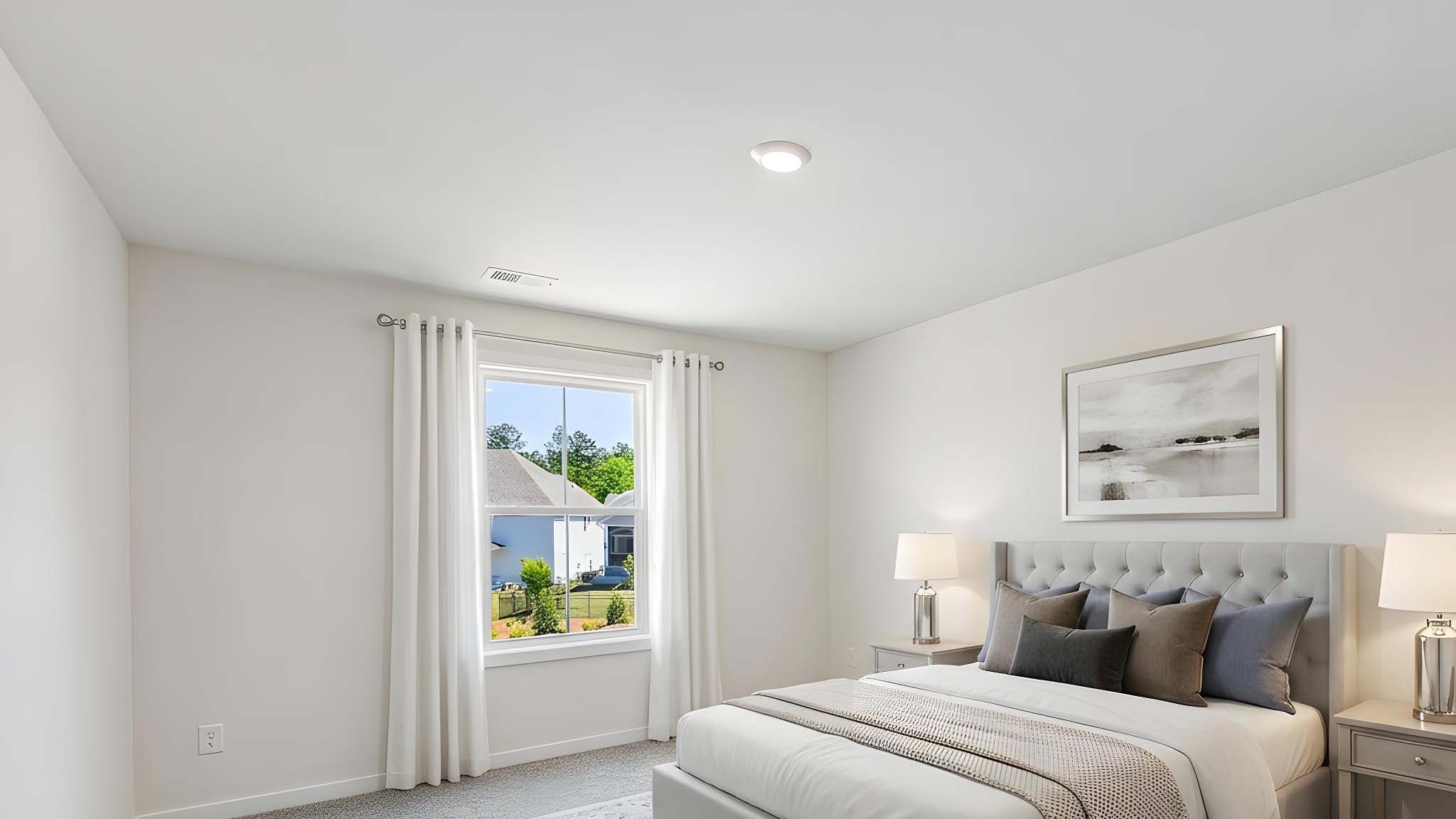 Carpeted bedroom with windows