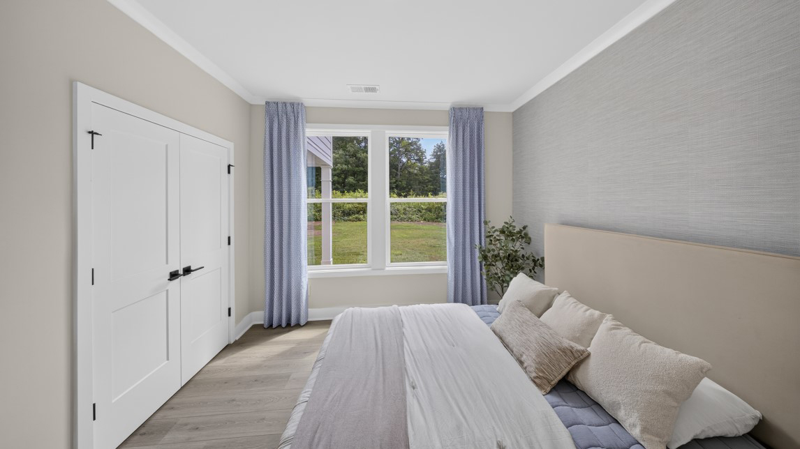 Carpeted bedroom with windows