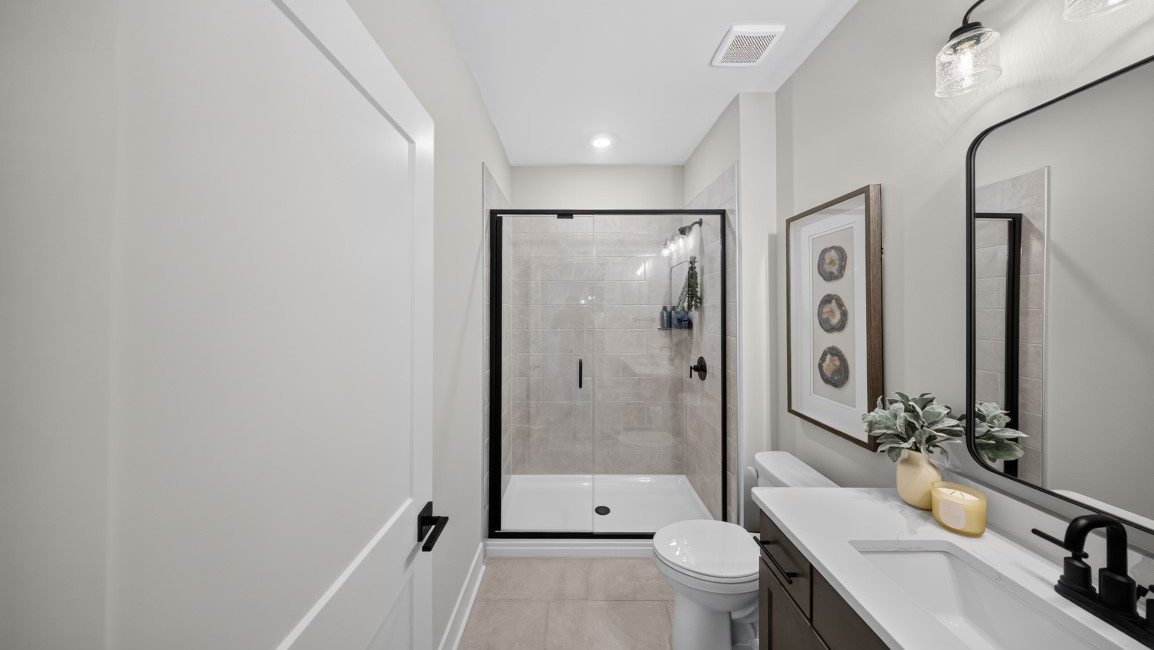 Bathroom with standing glass shower and sink